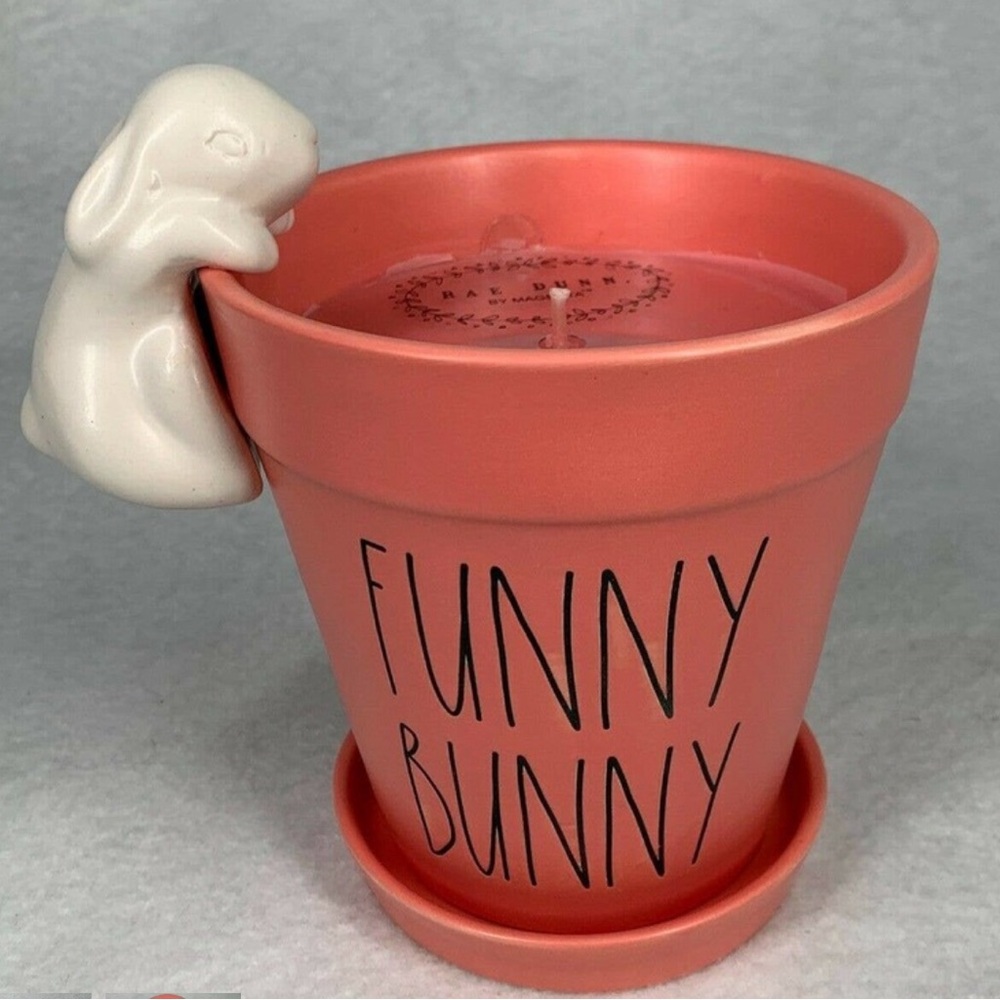 Rae Dunn FUNNY BUNNY Candle / Planter with Figural Bunny hanging off the edge.